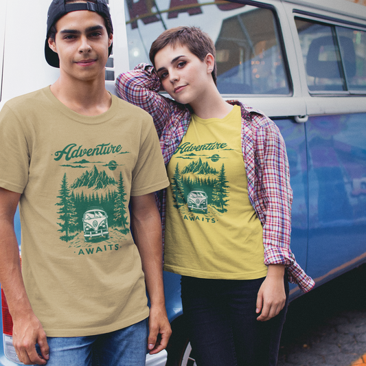 Two people wearing 'Adventure Awaits' t-shirts in front of a vintage van.