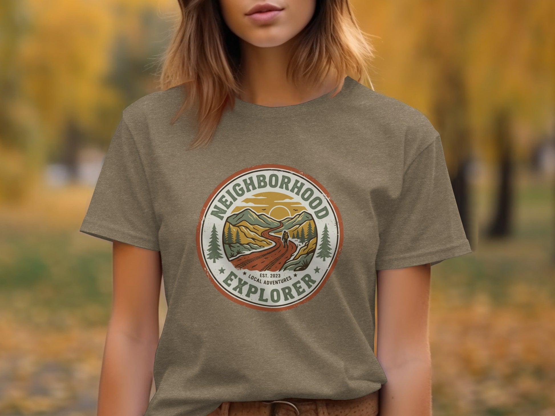 The Original Neighborhood Explorer Adventure Adventure Top: Circular logo on a brown t-shirt depicts a mountain landscape with text.