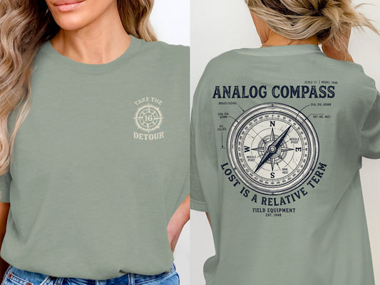Green t-shirt with analog compass design and "Take the Detour" text.