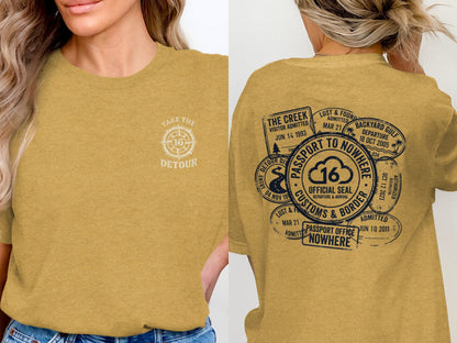 Yellow t-shirt with vintage passport stamps and "Take the Detour" graphic.