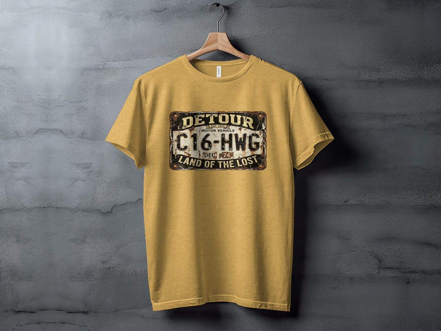 Detour 'Land of the Lost' Vintage | Vintage Outdoor Apparel: Yellow t-shirt with "Detour Motor Vehicle C16-HWG Land of the Lost" license plate graphic.