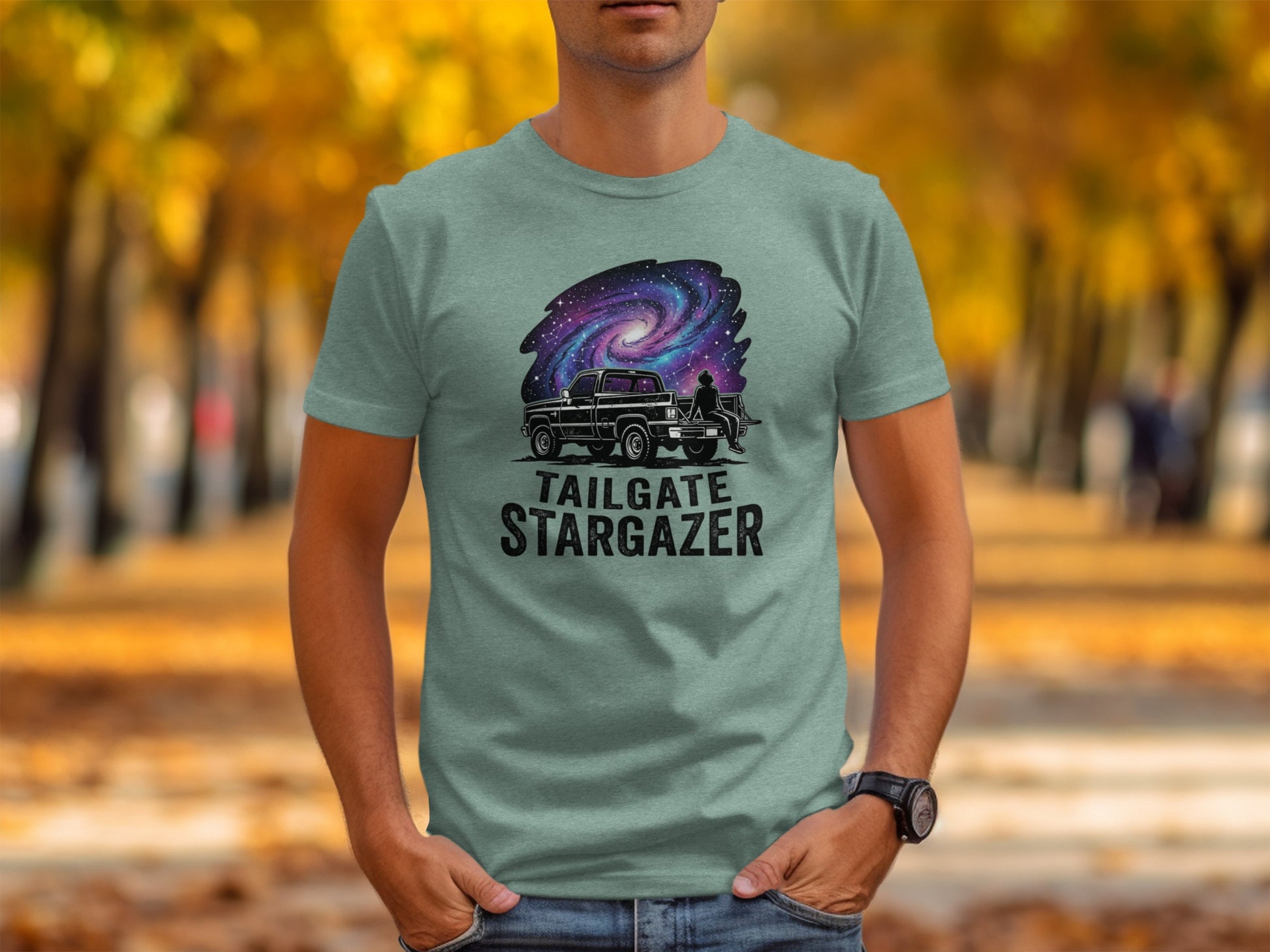 Heritage Cosmic Tailgate Stargazer Nomad Tee: Gray t-shirt with galaxy, truck, and "TAILGATE STARGAZER" text.