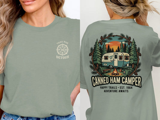 Green t-shirt with "Canned Ham Camper" graphic and "Adventure Awaits" text.
