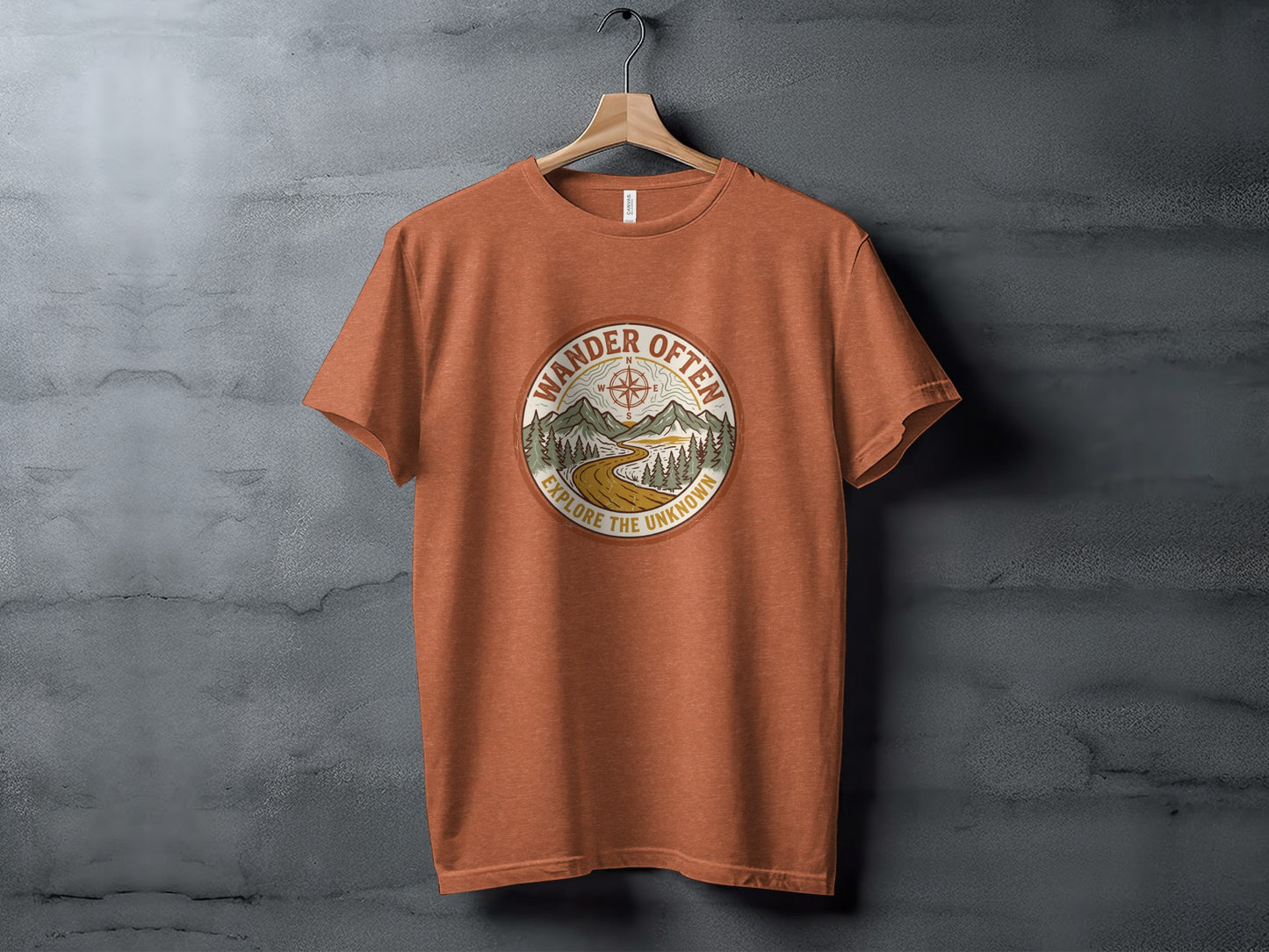 The Original Wander Often Vintage Explorer Adventure Top: Orange t-shirt with circular "Wander Often Explore the Unknown" graphic of mountains and compass.