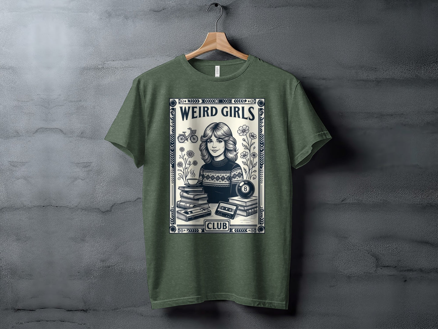 T-shirt with "Weird Girls Club" text and retro graphic of books, cassette, and billiard ball.