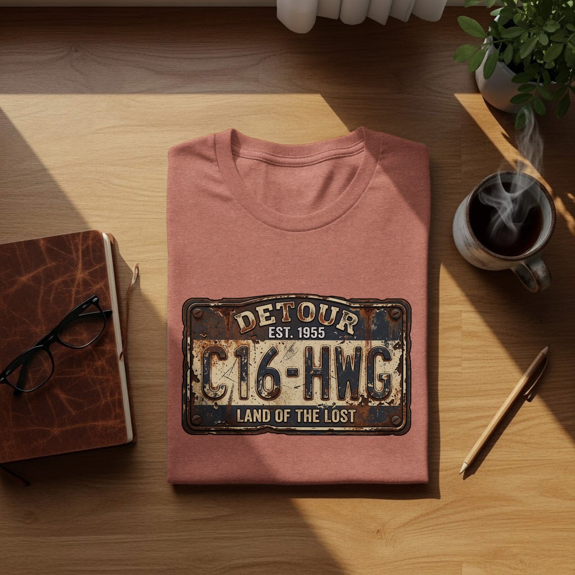 Land of the Lost Detour Plate: The Explorer's Adventure Tee: T-shirt with "DETOUR EST. 1955 C16-HWG LAND OF THE LOST" license plate graphic.