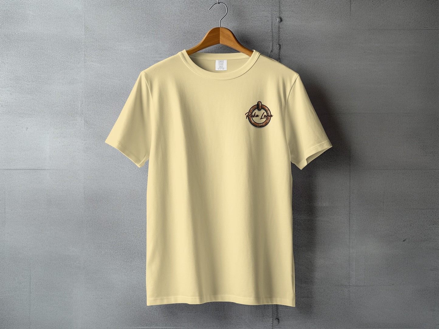 Pale yellow t-shirt with a circular logo on the left chest.