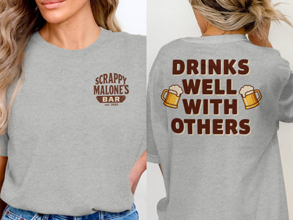 Drinks Well With Others Funny Party Social Graphic T-Shirt T-shirt - Scrappy Malone's Bar 100-Proof Humor - Cloud 16 Clothing Co.