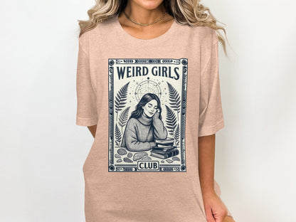 Peach t-shirt with "Weird Girls Club" text and a woman reading.