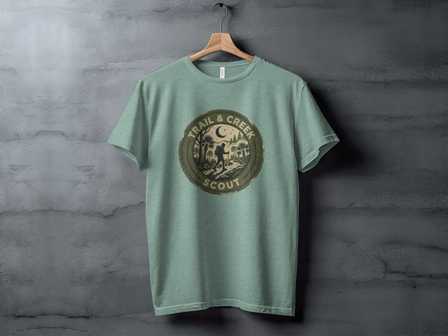 Heritage Trail & Creek Scout Adventure Nomad Tee: Circular patch with "Trail & Creek Scout" and woodland scene on a light green t-shirt.