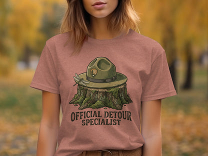 Official Detour Specialist Heritage | Vintage Outdoor Apparel: Ranger hat on a stump with a dragonfly, "OFFICIAL DETOUR SPECIALIST" text.