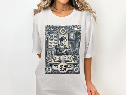 T-shirt graphic of a woman studying butterflies and clocks, with "Weird Girls Club" text.