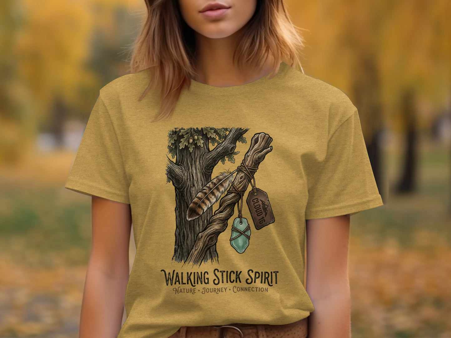 Heritage Walking Stick Spirit: Journey Nomad Tee: T-shirt graphic of a rustic branch with a feather and blue stone, text reads "WALKING STICK SPIRIT".