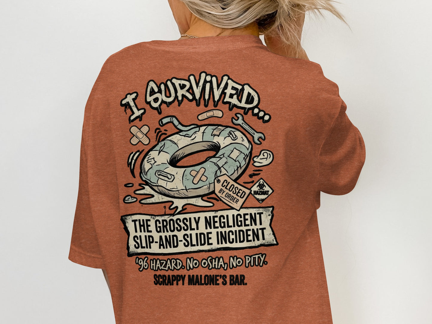 T-shirt graphic: "I Survived The Grossly Negligent Slip-and-Slide Incident" with a donut tube.