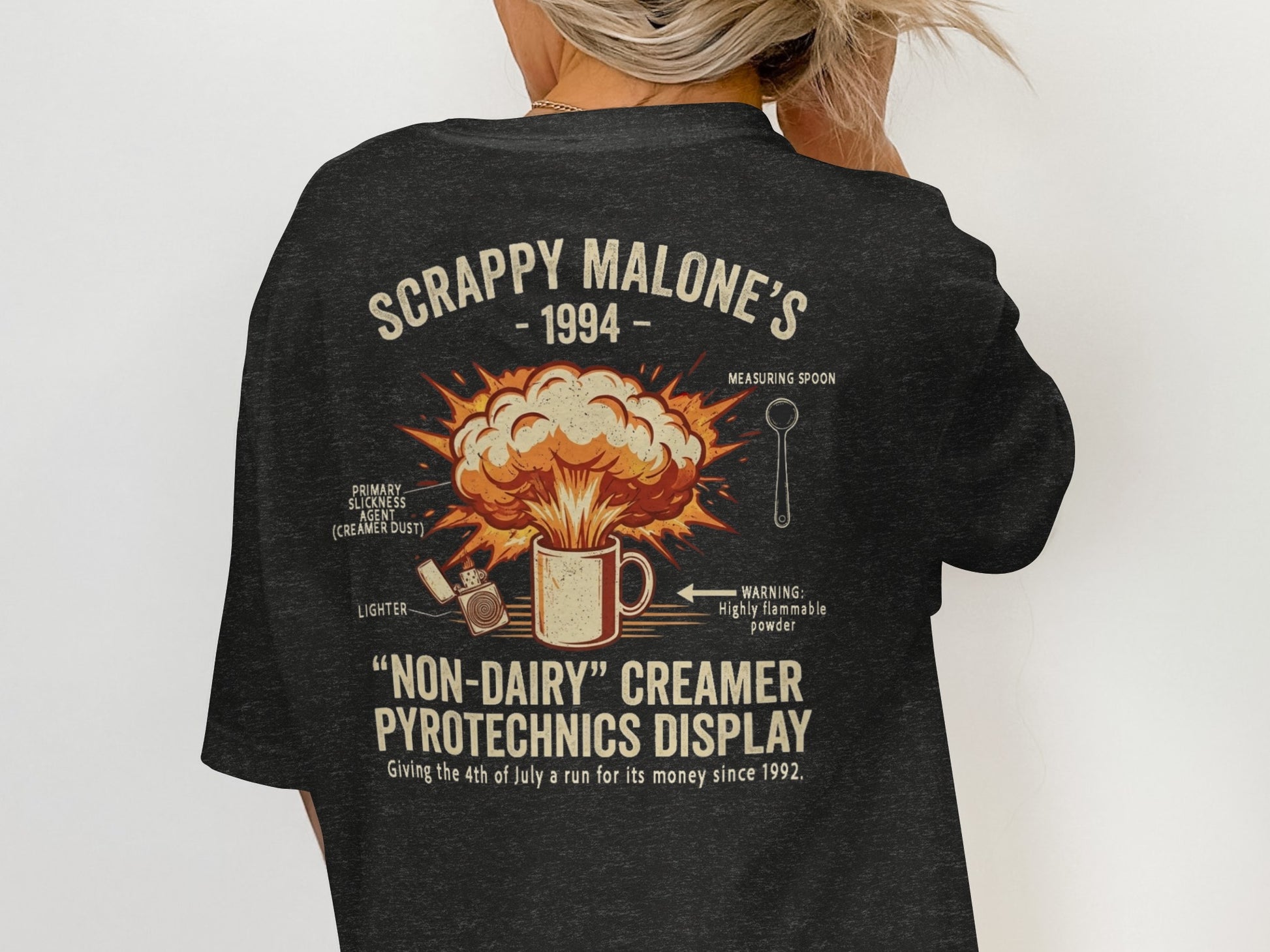 T-shirt with "Scrappy Malone's 1994 Non-Dairy Creamer Pyrotechnics Display" graphic.