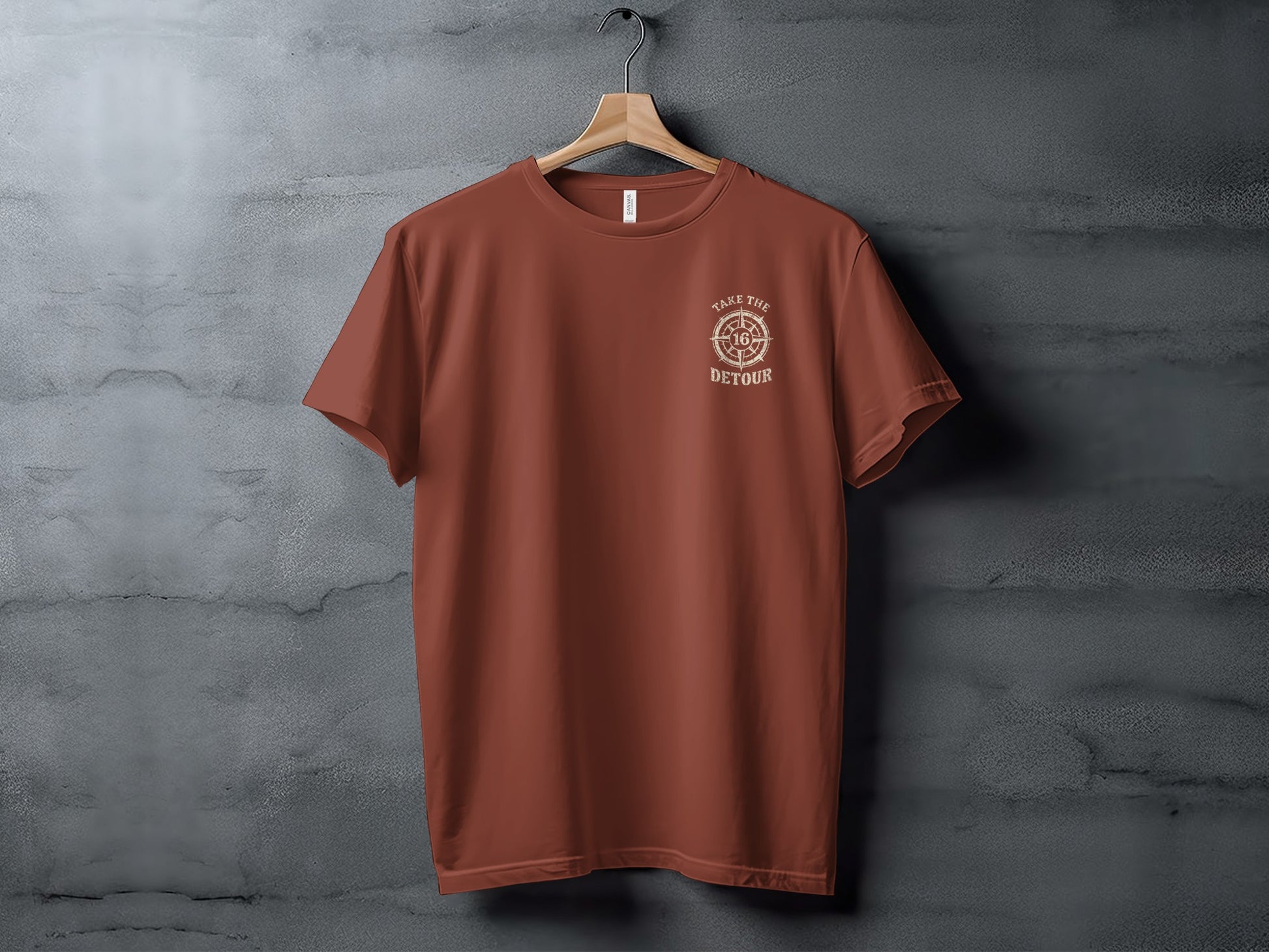 Rust-colored t-shirt with "Take the Detour" compass graphic on chest.
