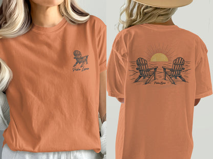 Orange t-shirt with Puka Luna logo on front and beach chairs at sunset graphic on back.