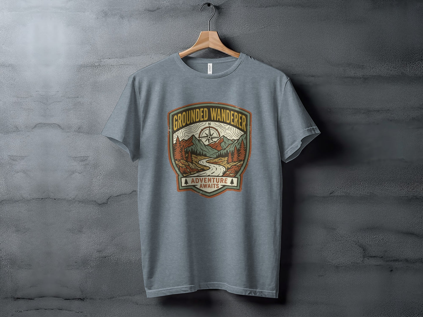 Heritage Grounded Wanderer Adventure Nomad Tee: Gray t-shirt with "Grounded Wanderer Adventure Awaits" mountain landscape graphic.