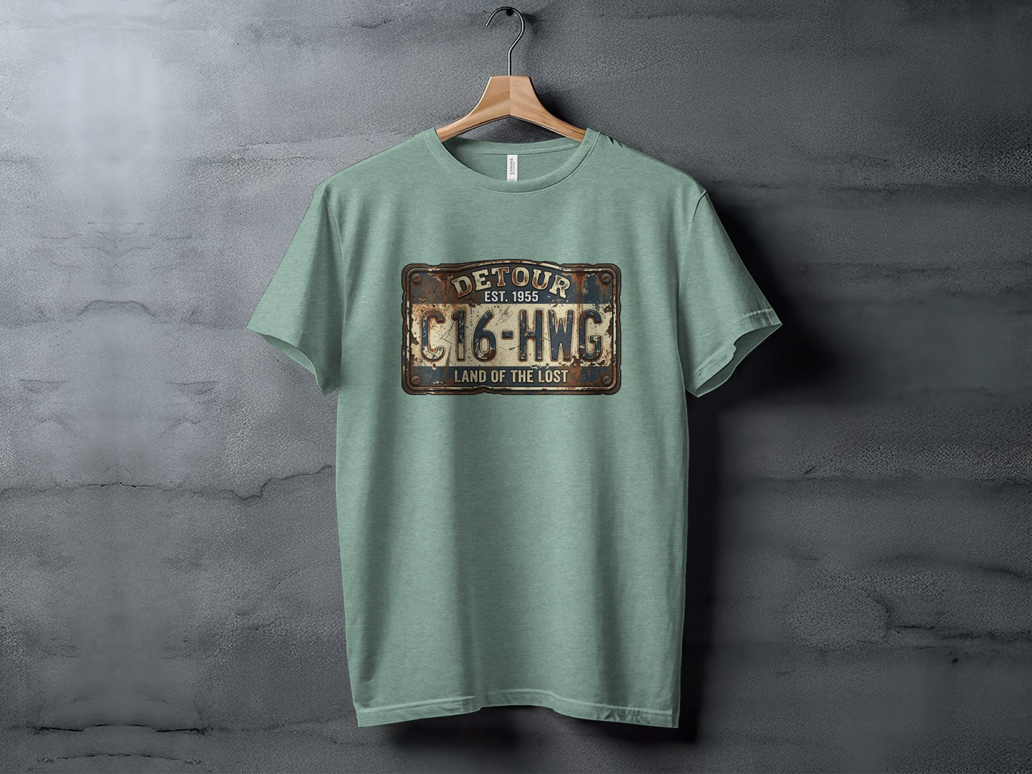 Land of the Lost Detour Plate: The Explorer's Adventure Tee: Green t-shirt with "DETOUR EST. 1955 C16-HWG LAND OF THE LOST" license plate graphic.