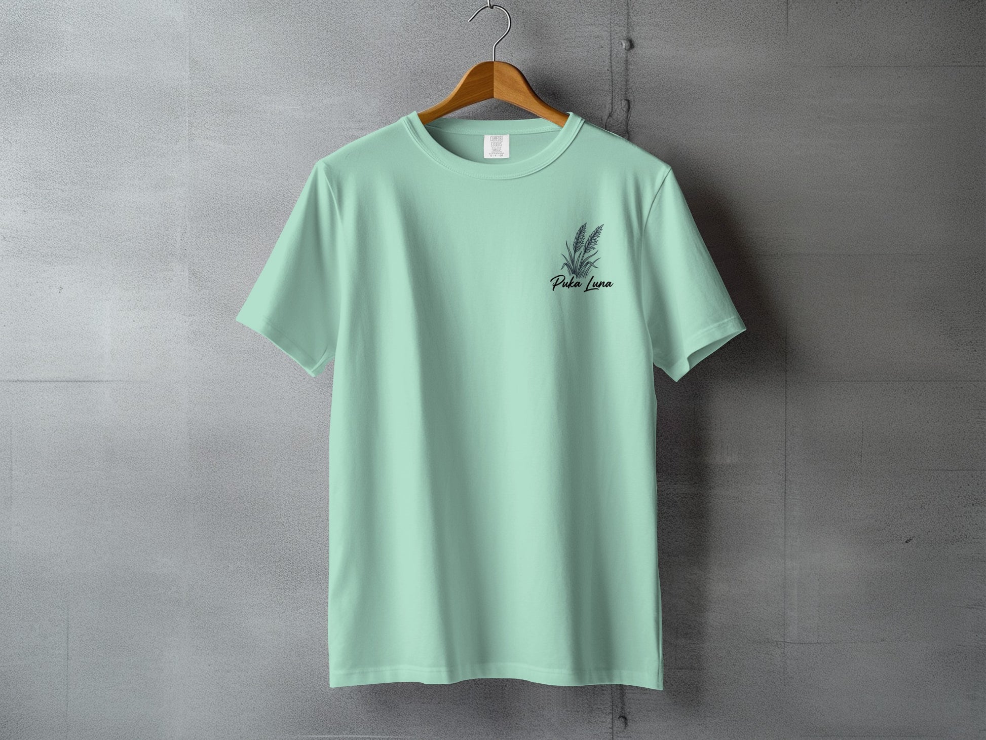Mint green t-shirt with "Pola Luna" text and small floral design.