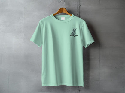 Mint green t-shirt with "Pola Luna" text and small floral design.