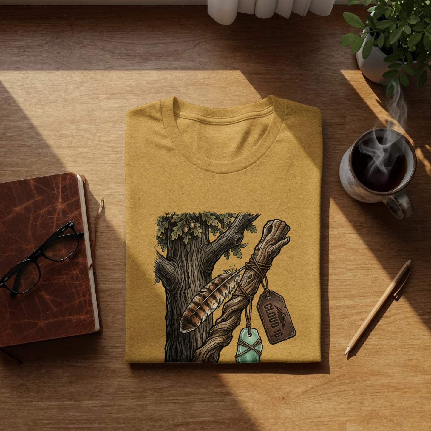 Heritage Walking Stick Spirit: Journey Nomad Tee: Mustard t-shirt with feather and tree branch graphic, "CLOUD 16" tag.