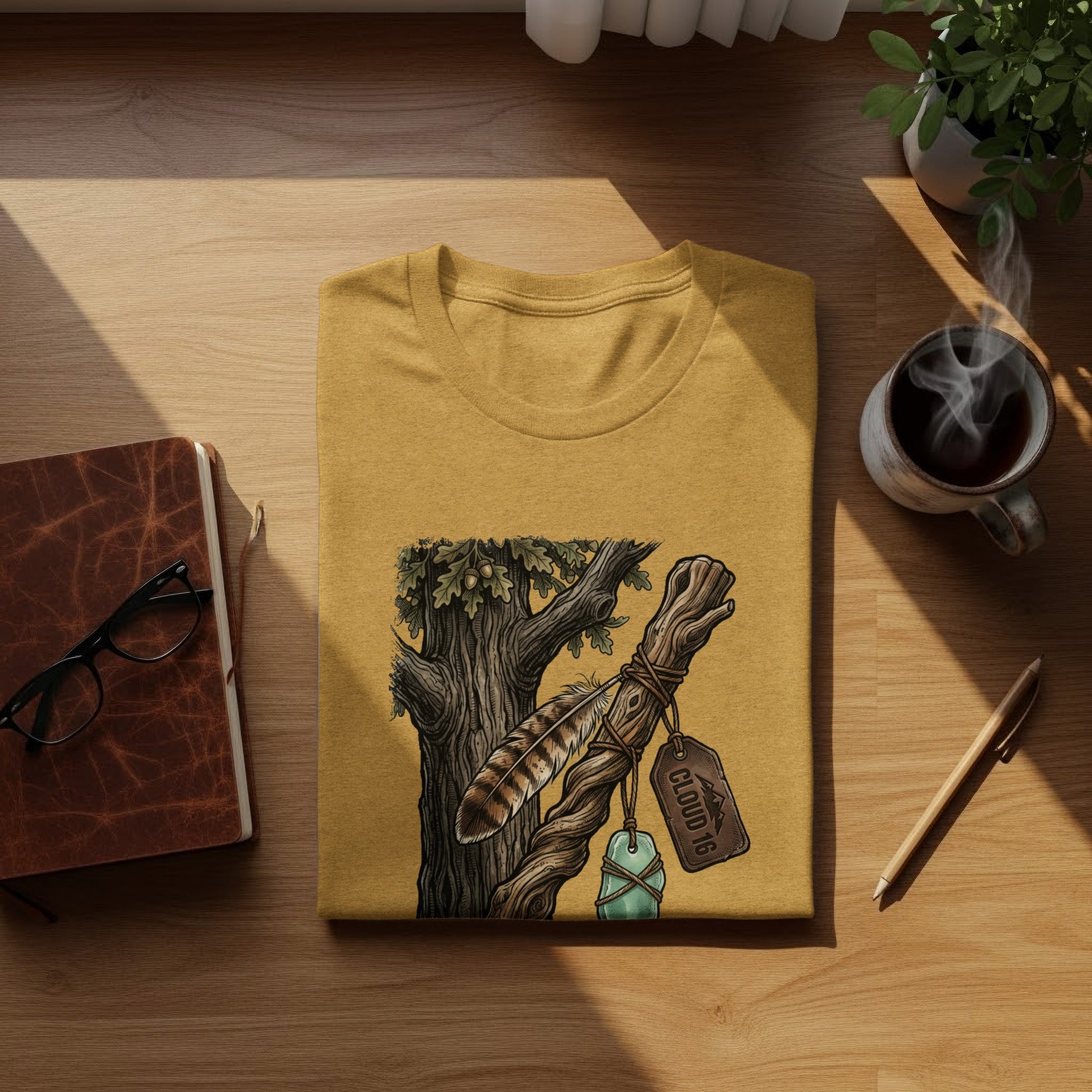 Heritage Walking Stick Spirit: Journey Nomad Tee: Mustard t-shirt with feather and tree branch graphic, "CLOUD 16" tag.