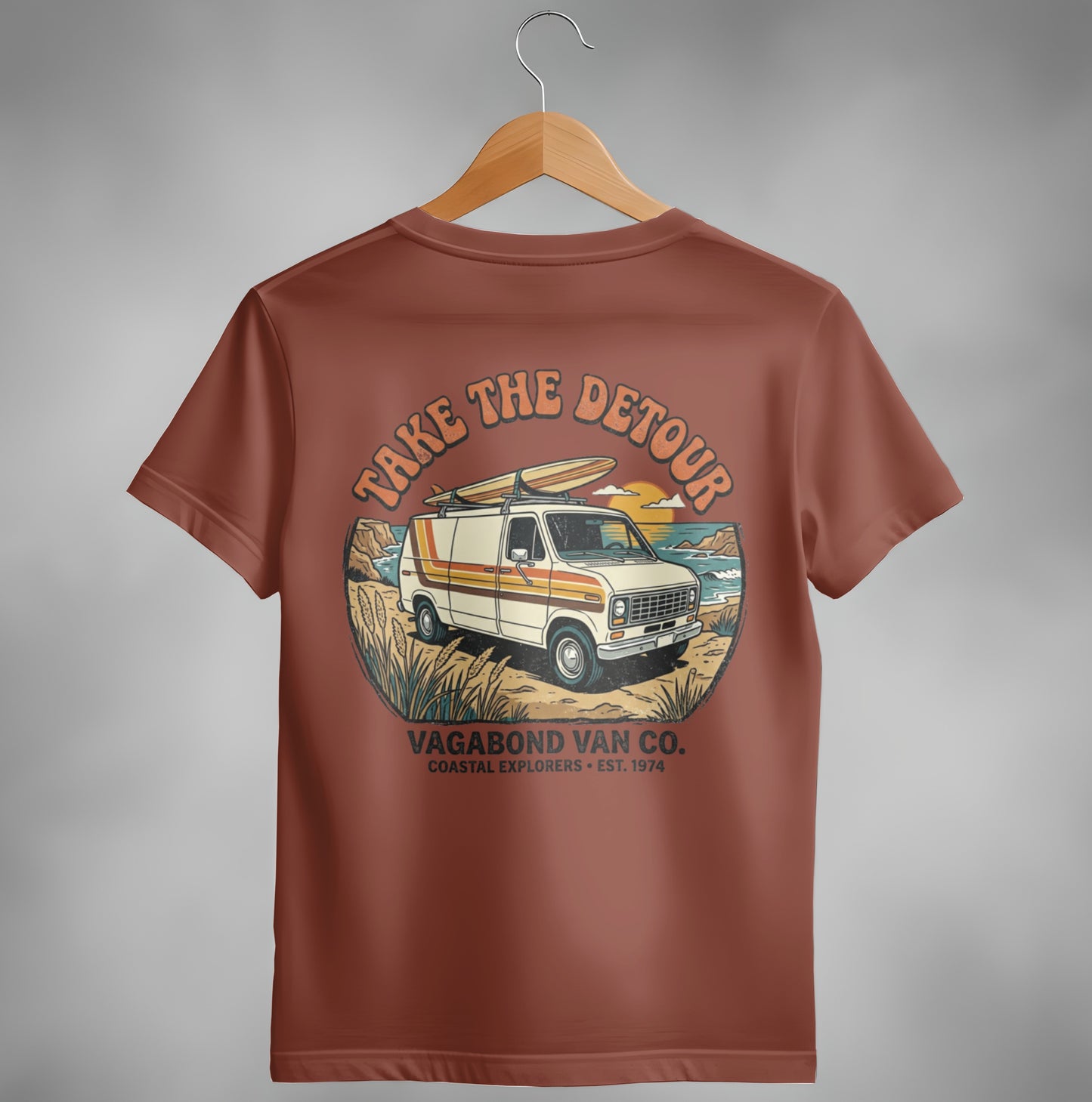 Brown t-shirt with "Take the Detour" van, surfboards, and coastal scene graphic.