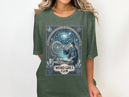 Woman wearing green t-shirt with celestial globe and "Weird Girls Club" text.