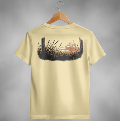T-shirt with cream color and a graphic of a shrimp boat at sunset.