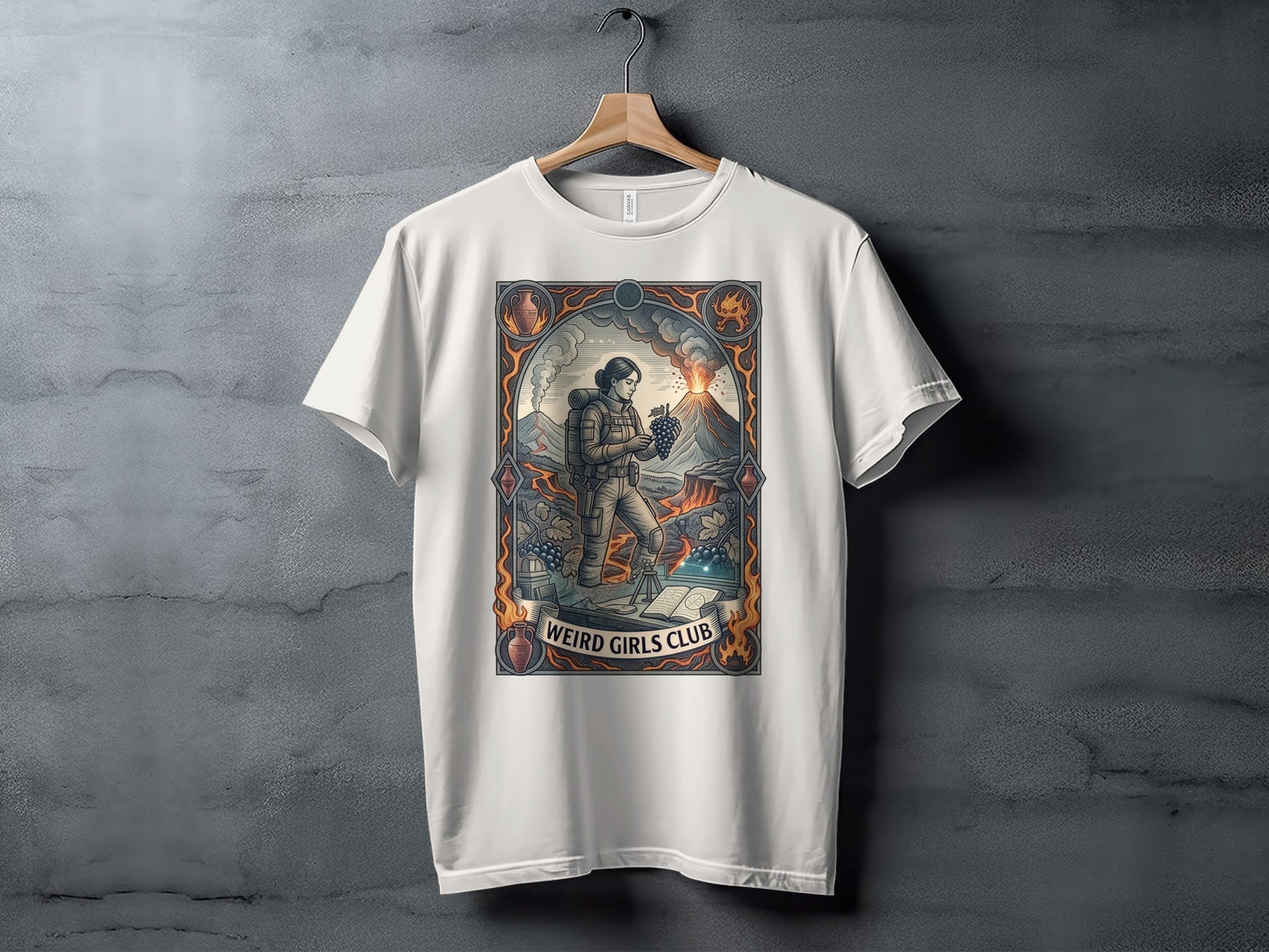 T-shirt with "Weird Girls Club" logo featuring astronaut and volcano illustration.