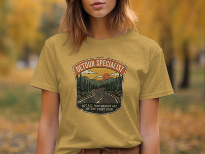 Heritage Detour Specialist Vintage Graphic Nomad Tee: Yellow t-shirt with "Detour Specialist" and "Not all who wander are on the right road" text.