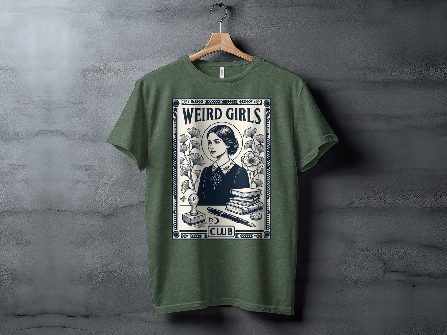Green t-shirt with "Weird Girls Club" and illustration of a woman, books, and quill.
