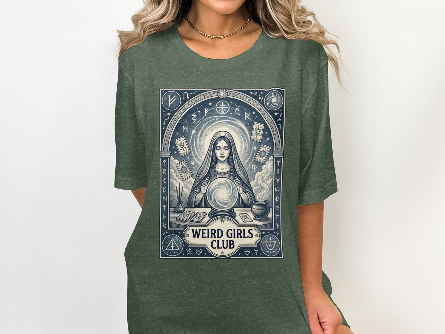 Woman wearing a dark green t-shirt with a mystical design.