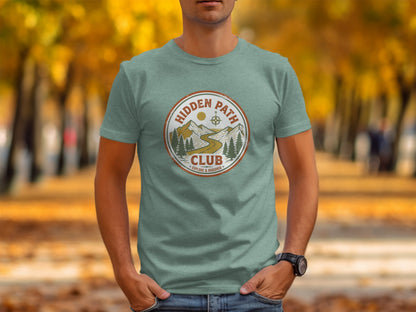 Rugged Hidden Path Club Explorer Wilderness Shirt: Light green t-shirt with "Hidden Path Club Explore & Discover" circular logo.