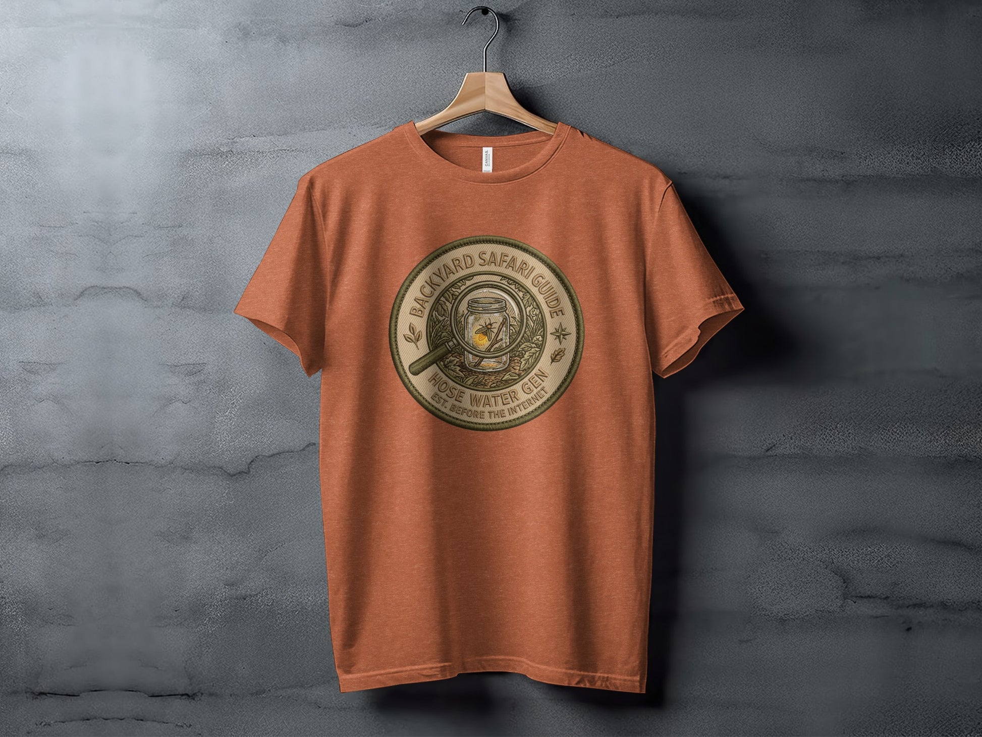 Backyard Safari Guide Explorer: Backcountry Outpost Shirt: Orange t-shirt with "Backyard Safari Guide" circular graphic.