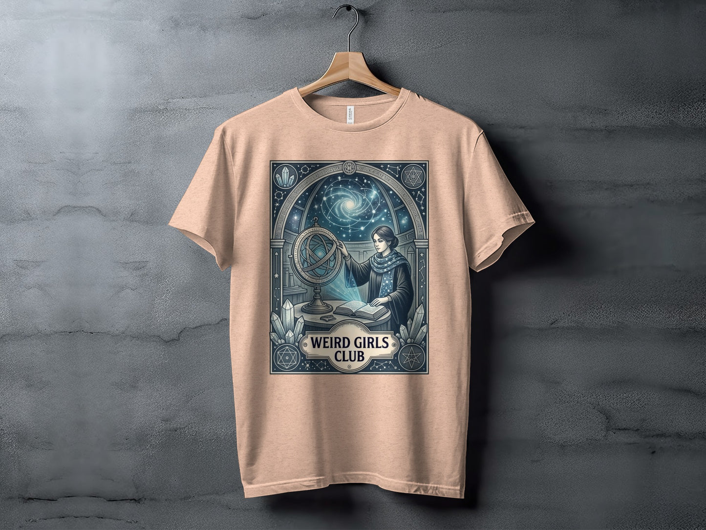 Cream t-shirt featuring a woman with a celestial orb and the text "Weird Girls Club".