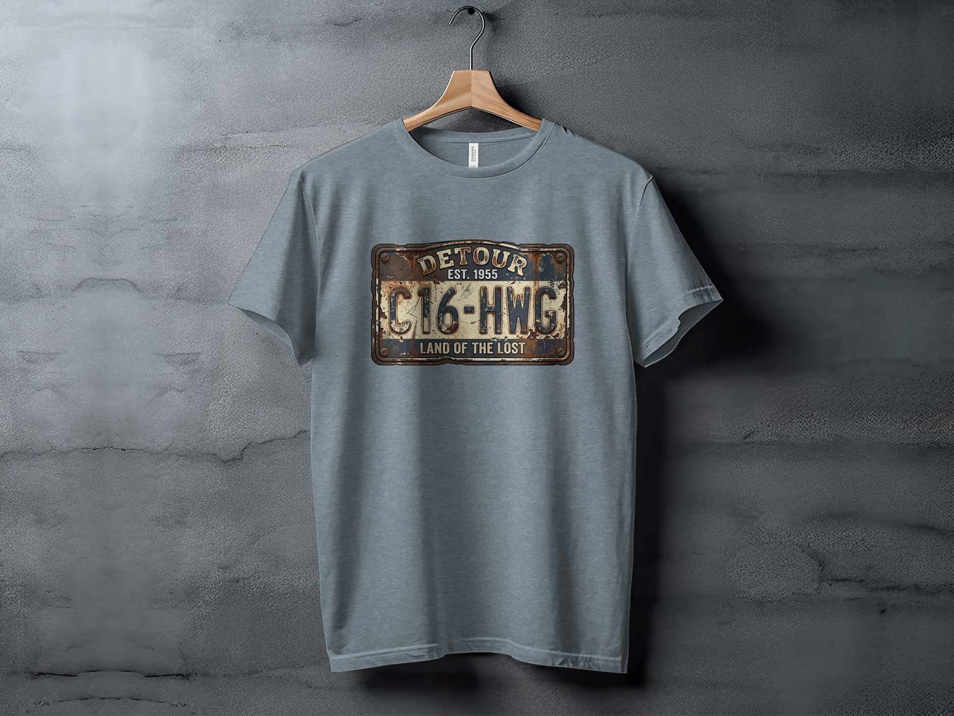 Land of the Lost Detour Plate: The Explorer's Adventure Tee: Grey t-shirt with "Detour Est. 1955 C16-HWG Land of the Lost" license plate graphic.