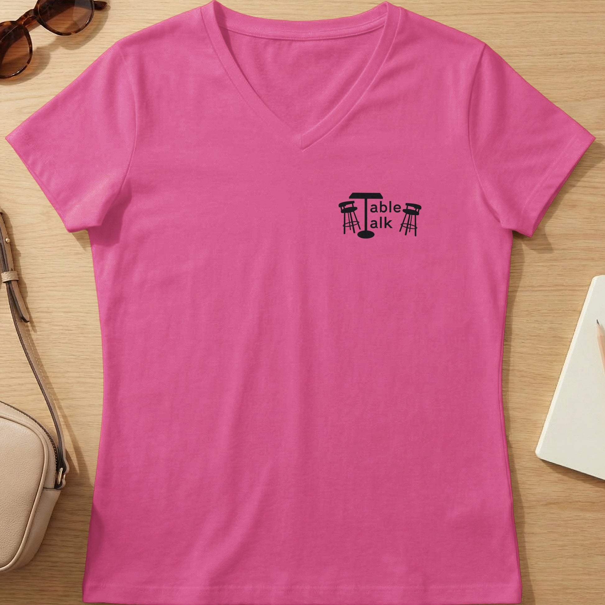Pink v-neck t-shirt with "Table Talk" logo featuring a table and chairs.