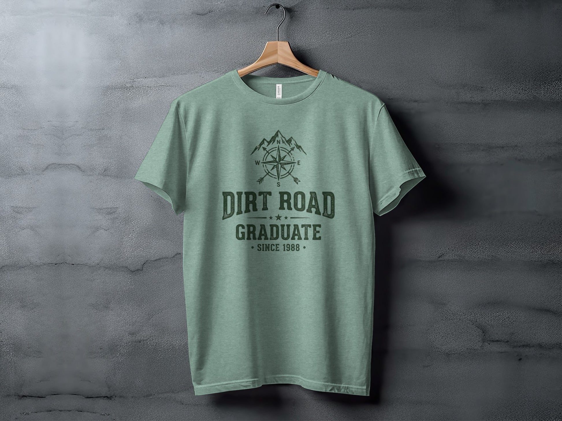 The Original Dirt Road Graduate Outdoor Adventure Top: Green t-shirt with "Dirt Road Graduate Since 1988" and compass graphic.