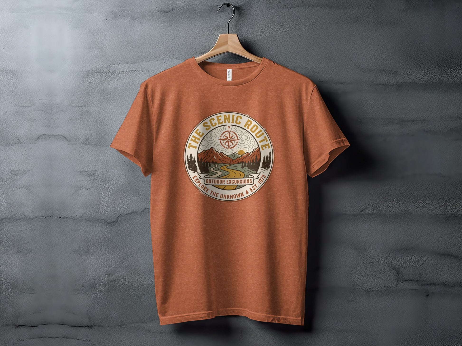 Heritage Scenic Route Vintage Explorer Tee Nomad Tee: Orange t-shirt with circular outdoor excursion graphic and text.