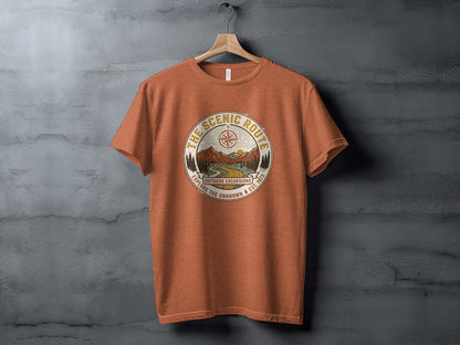 Heritage Scenic Route Vintage Explorer Tee Nomad Tee: Orange t-shirt with circular outdoor excursion graphic and text.