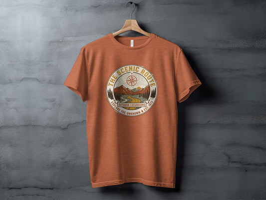 Heritage Scenic Route Vintage Explorer Tee Nomad Tee: Orange t-shirt with circular outdoor excursion graphic and text.