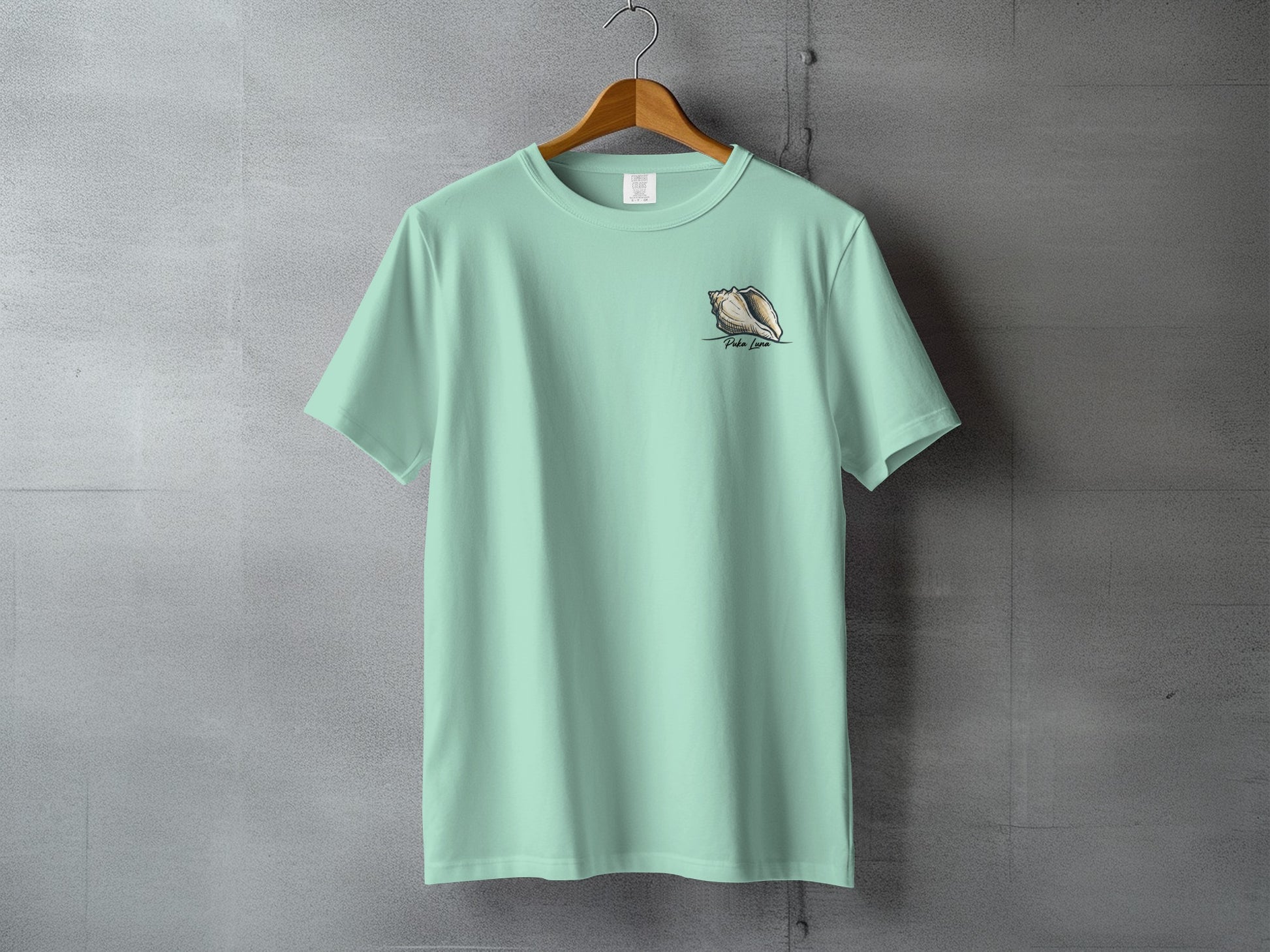 Mint green t-shirt with a conch shell design on the left chest.