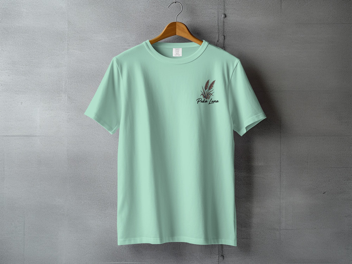 Mint green t-shirt with "Pura Luna" text and red floral detail.