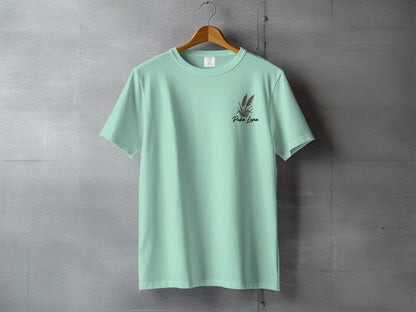 Mint green t-shirt with "Pura Luna" text and red floral detail.