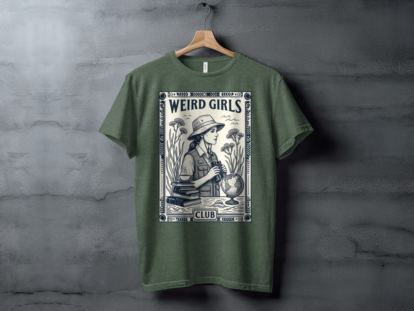 Green t-shirt with "Weird Girls Club" graphic of a woman with binoculars and globe.
