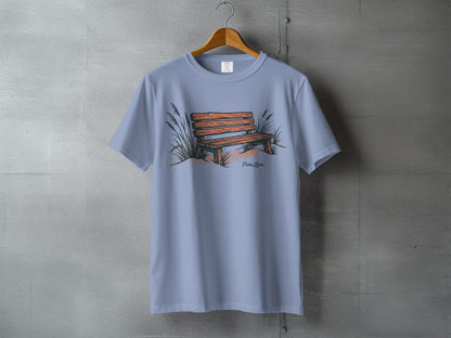 Light blue t-shirt with a drawn beach bench and dune grass.