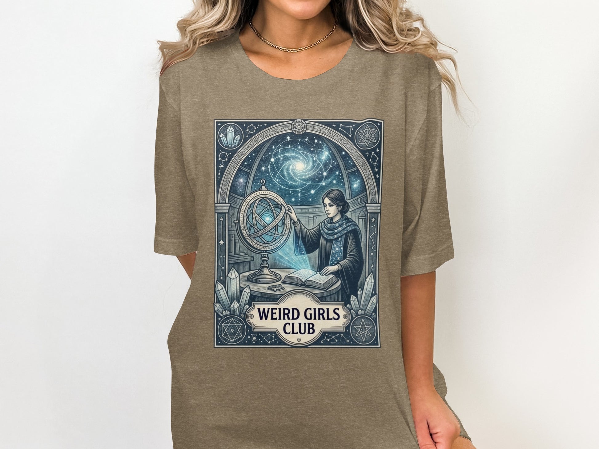 T-shirt graphic with celestial map, astrolabe, and "Weird Girls Club" text.