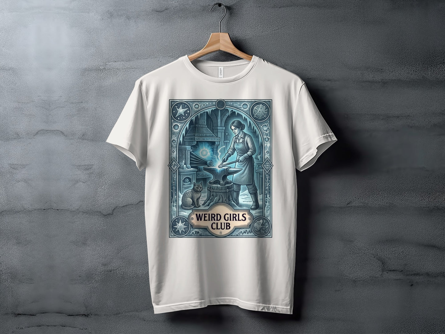 T-shirt featuring a woman blacksmith with a cat, text "Weird Girls Club".